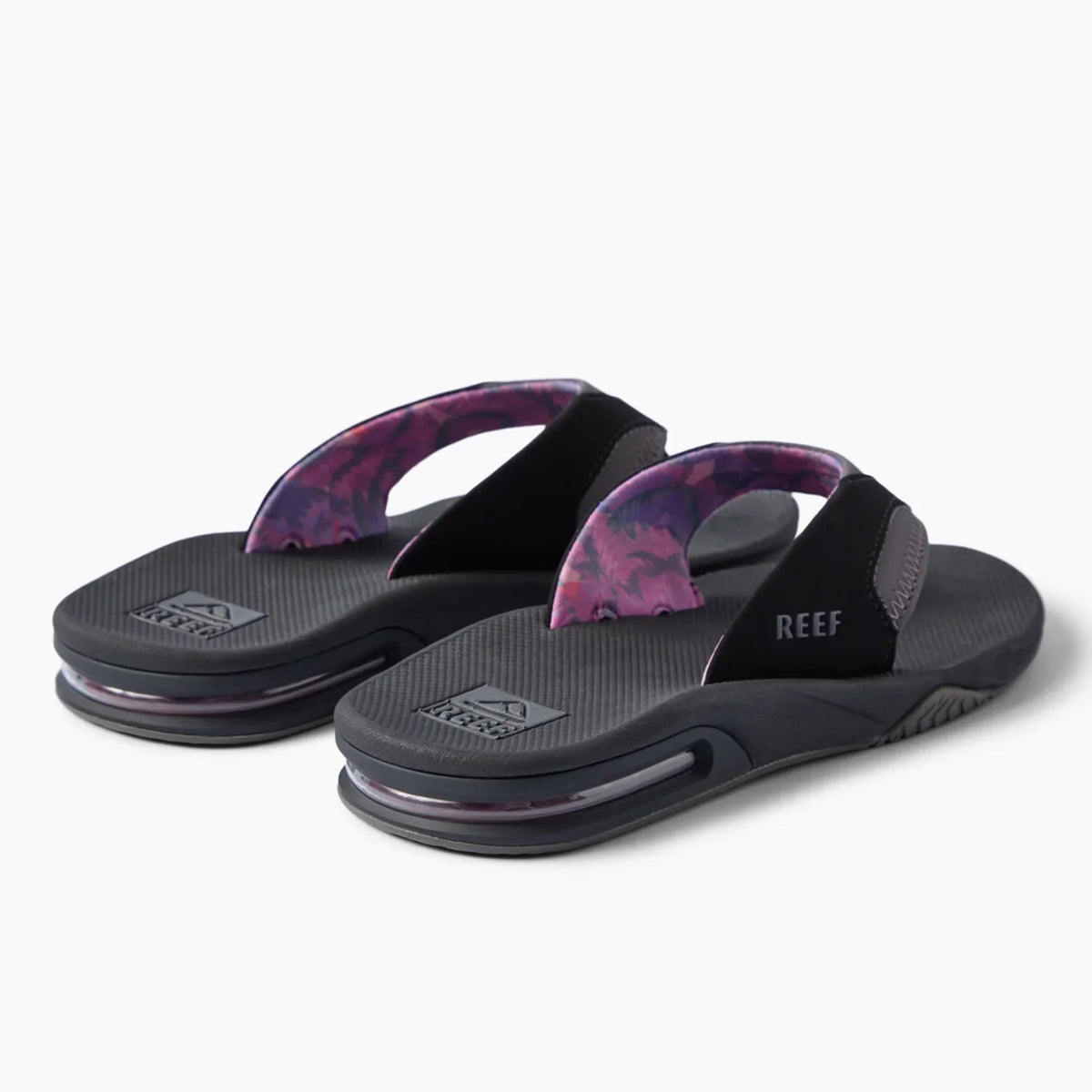 REEF Fanning black flip flops facing left with patterned straps and cushioned footbeds