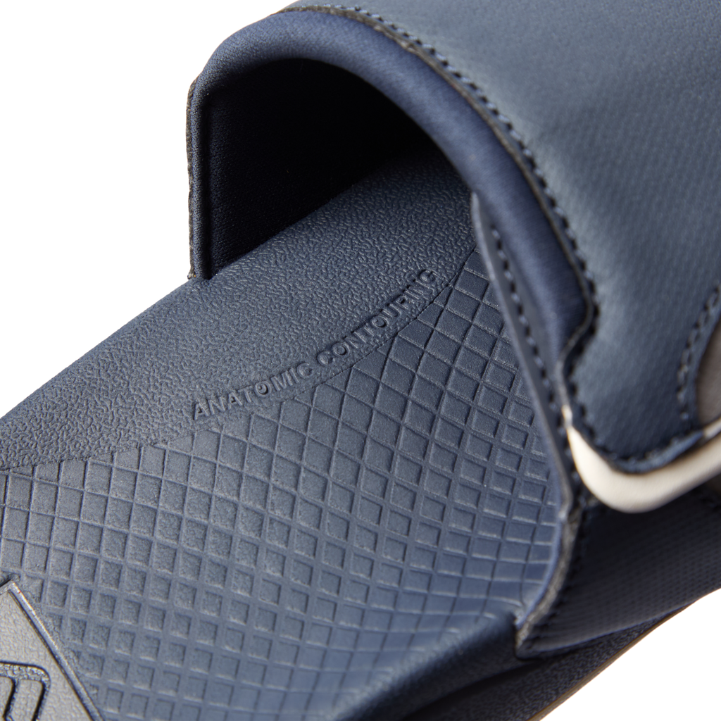 Fanning + Slide close-up of navy blue footbed and strap showing anatomical contour and soft-rebound cushioning features