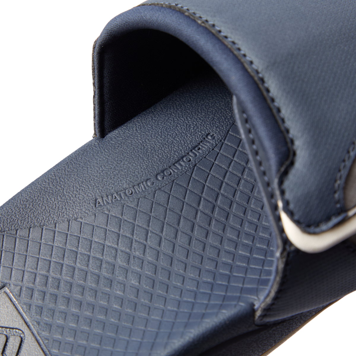 Fanning + Slide close-up of navy blue footbed and strap showing anatomical contour and soft-rebound cushioning features