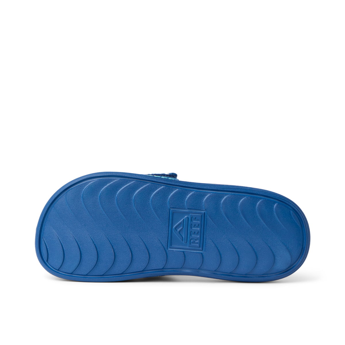 Kids Salty Slide outsole facing up, showing durable, water-friendly sole with anatomical arch support and REEF branding.
