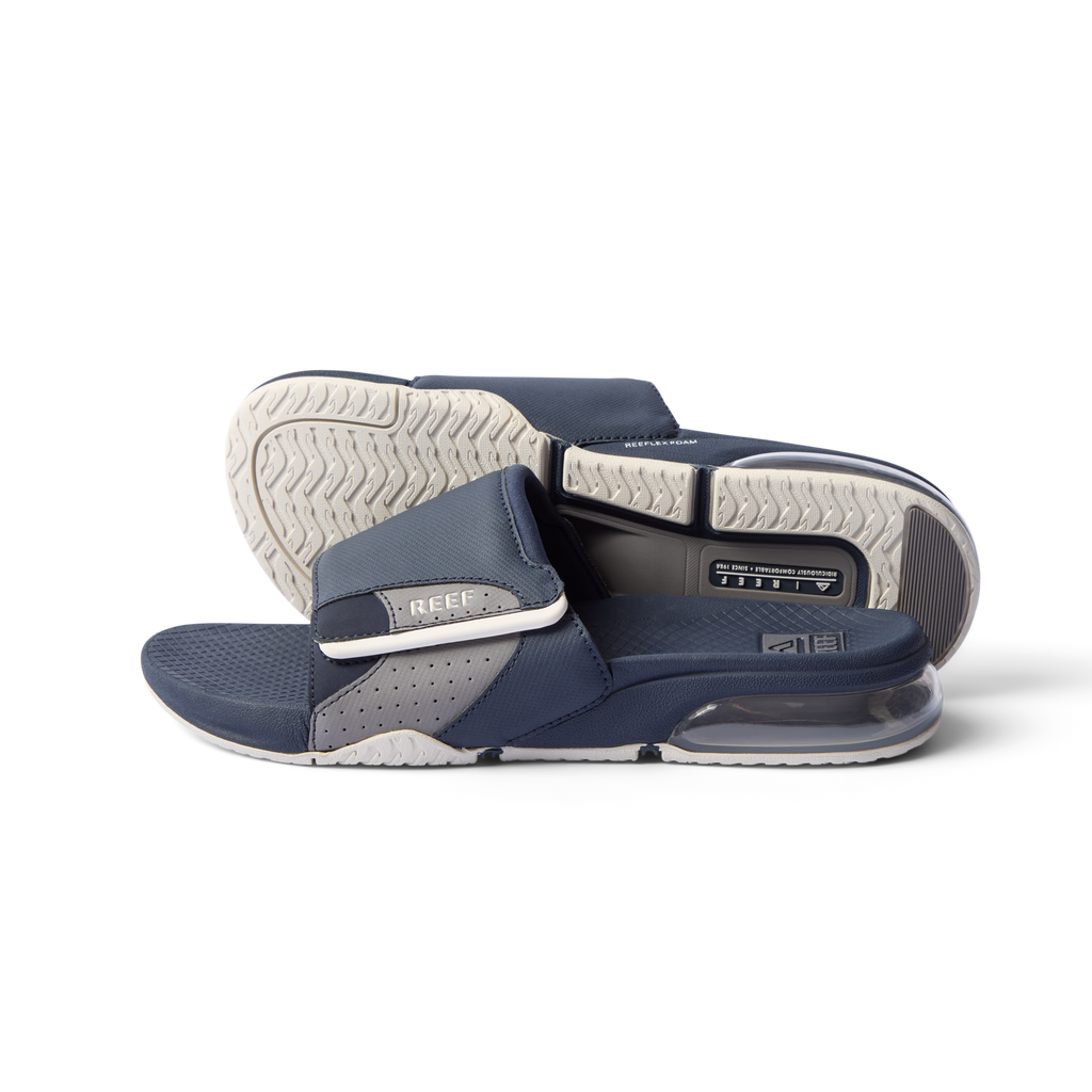 Fanning + Slide sandals facing left with navy and grey water-friendly straps, cushioned footbed, and oversized airbag heel for comfort