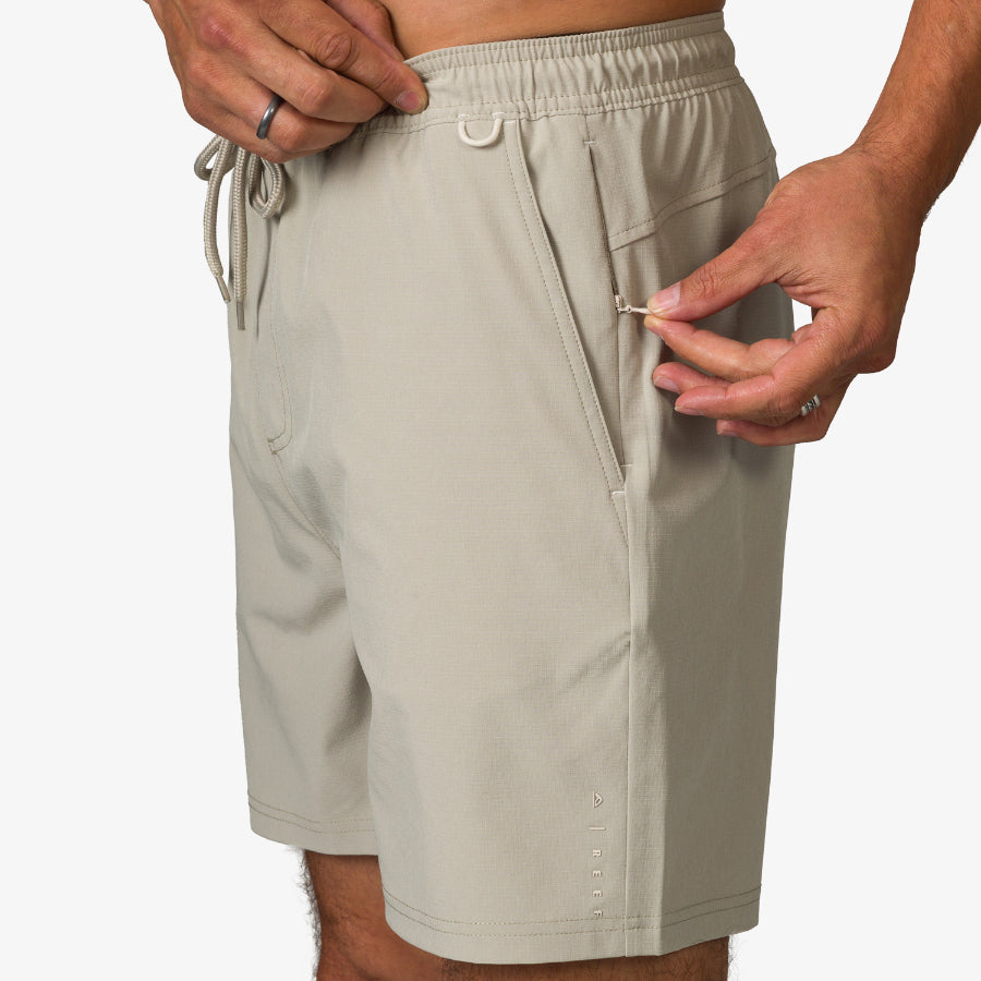 Close-up of the right side of Rushmore Hybrid Short in light stone, showing zippered pocket detail and comfort fit.