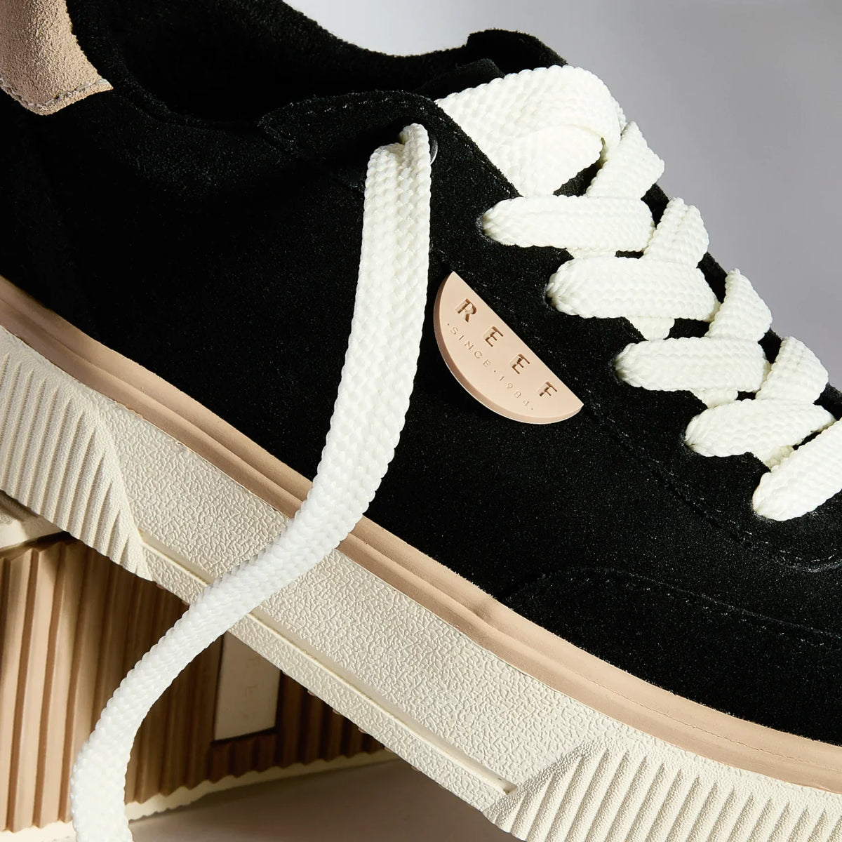 Close-up of the left side of Lay Day Lift sneaker facing right, featuring white laces and anatomical arch support.
