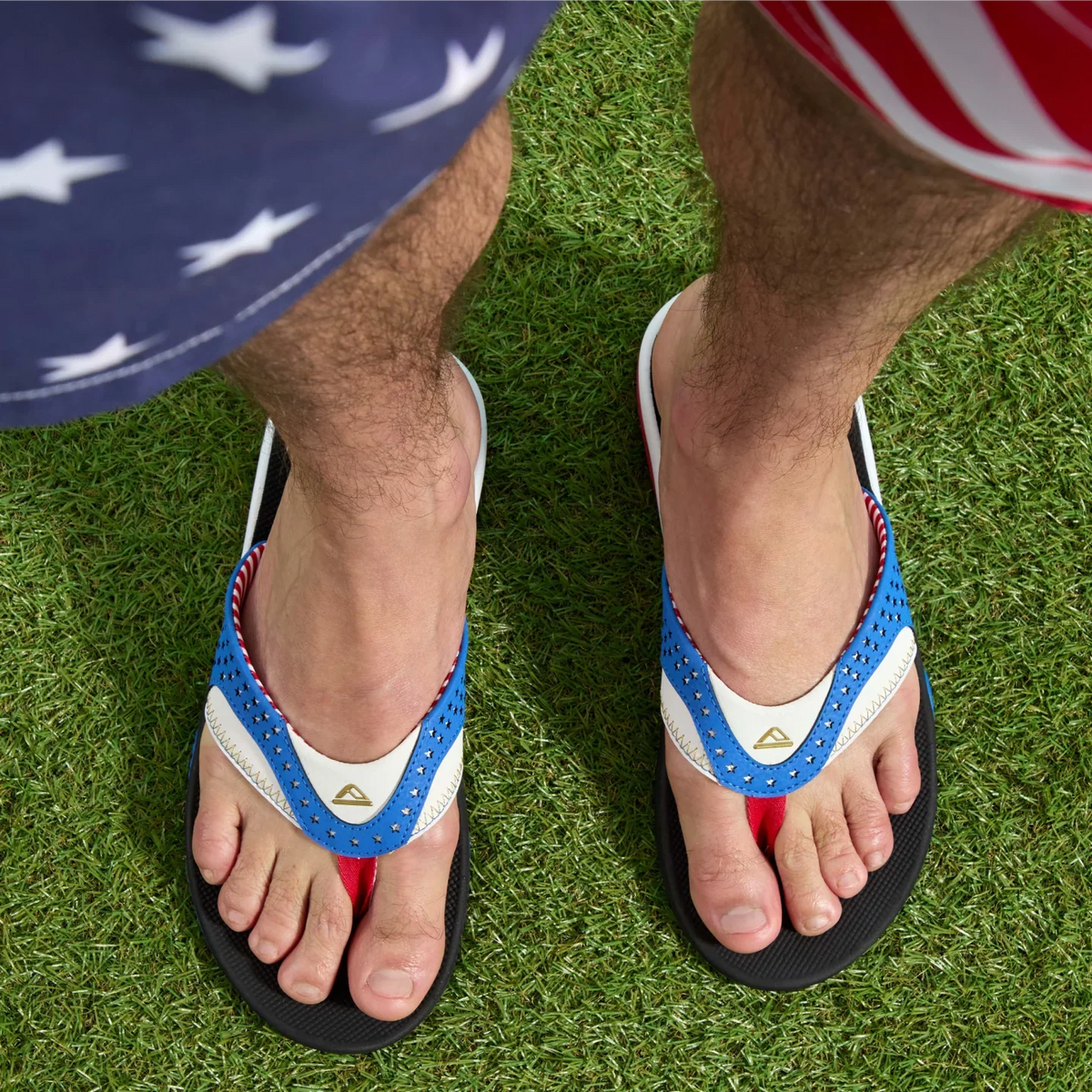 Fanning men’s sandals facing forward, close-up on toes and straps, beach-inspired comfort with arch support and cushioning.