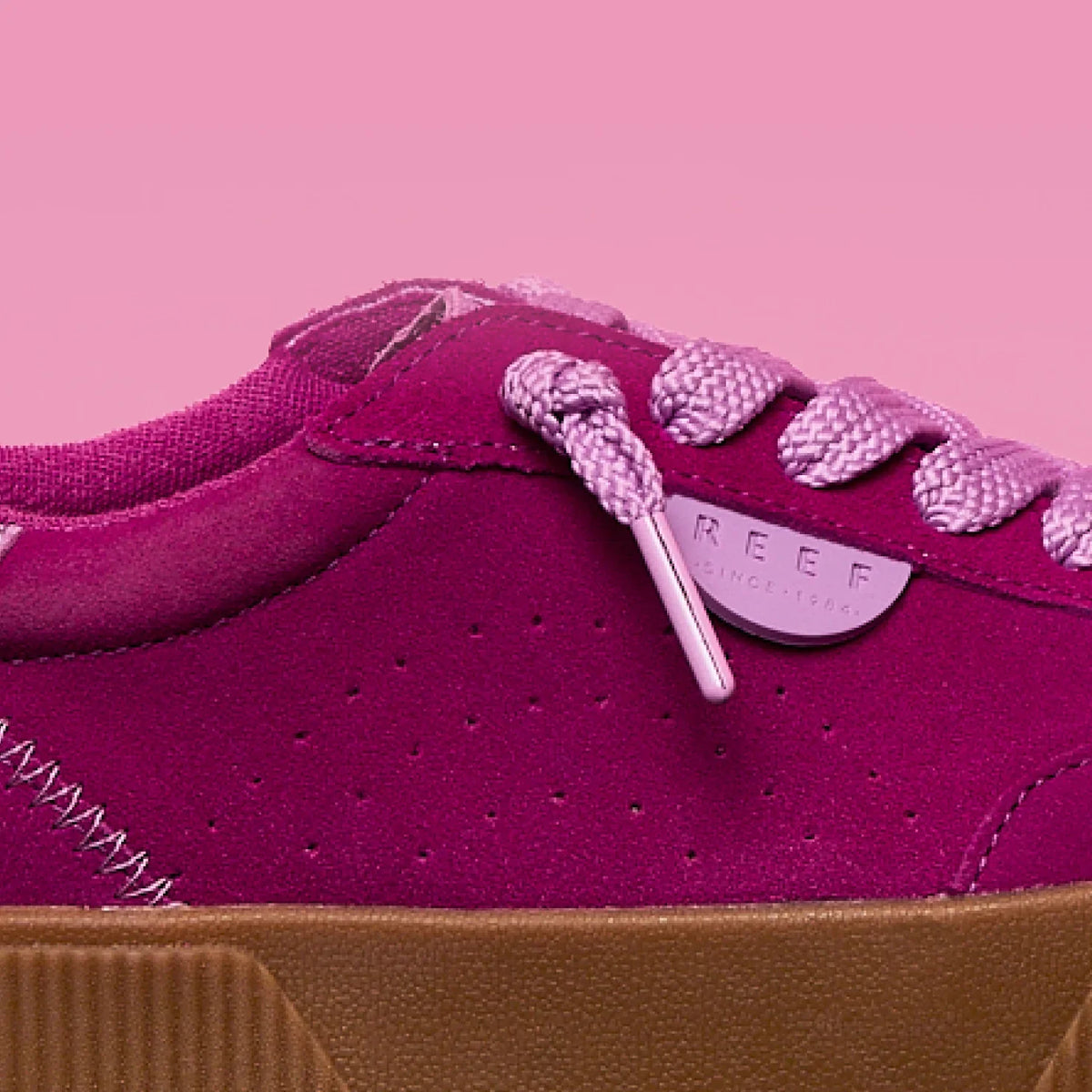 Close-up side view of the left Lay Day Seas sneaker in orchid with REEF branding, durable sole, and comfort features.