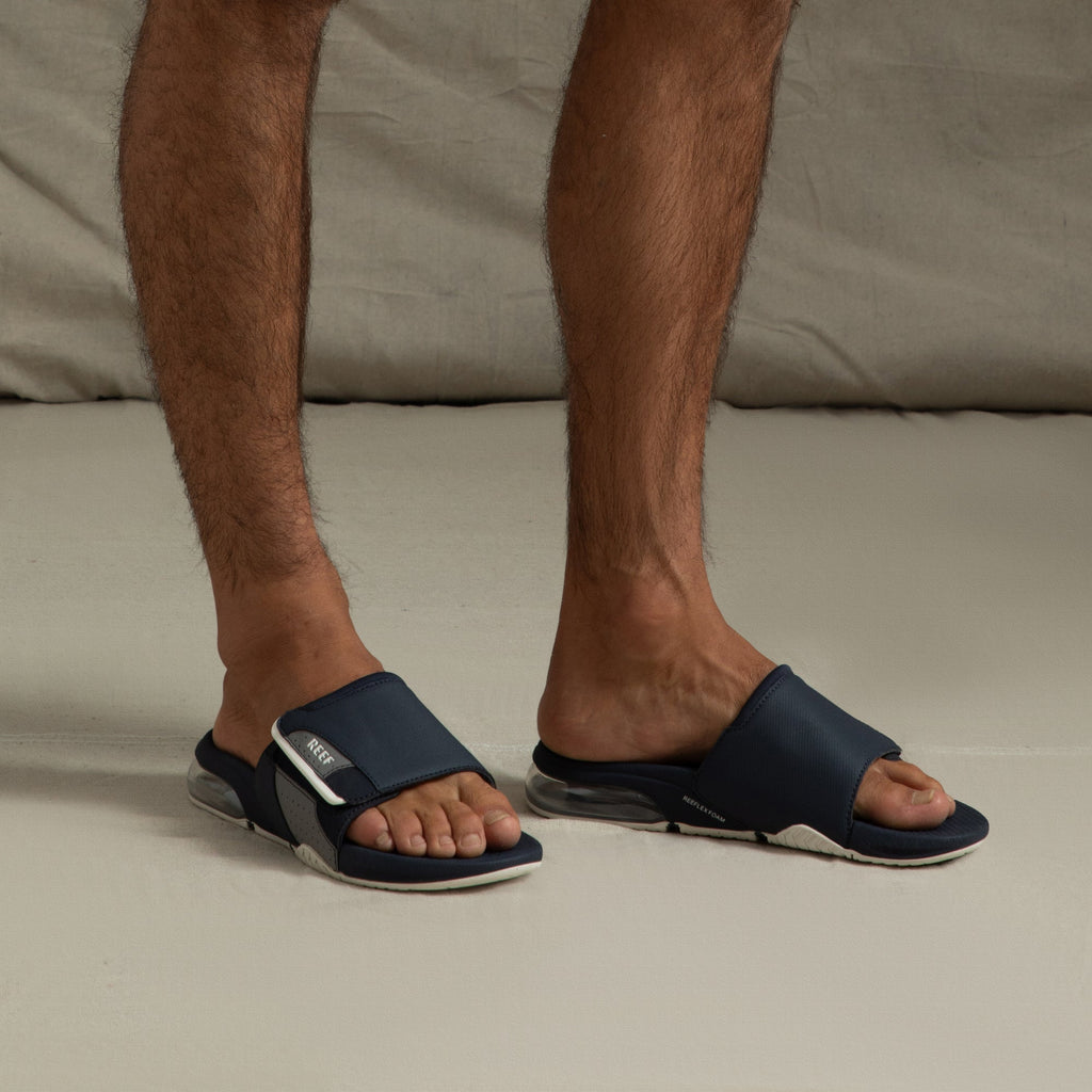 Fanning + Slide sandals facing forward with navy blue soft-rebound EVA straps and oversized airbag heel for all-day comfort