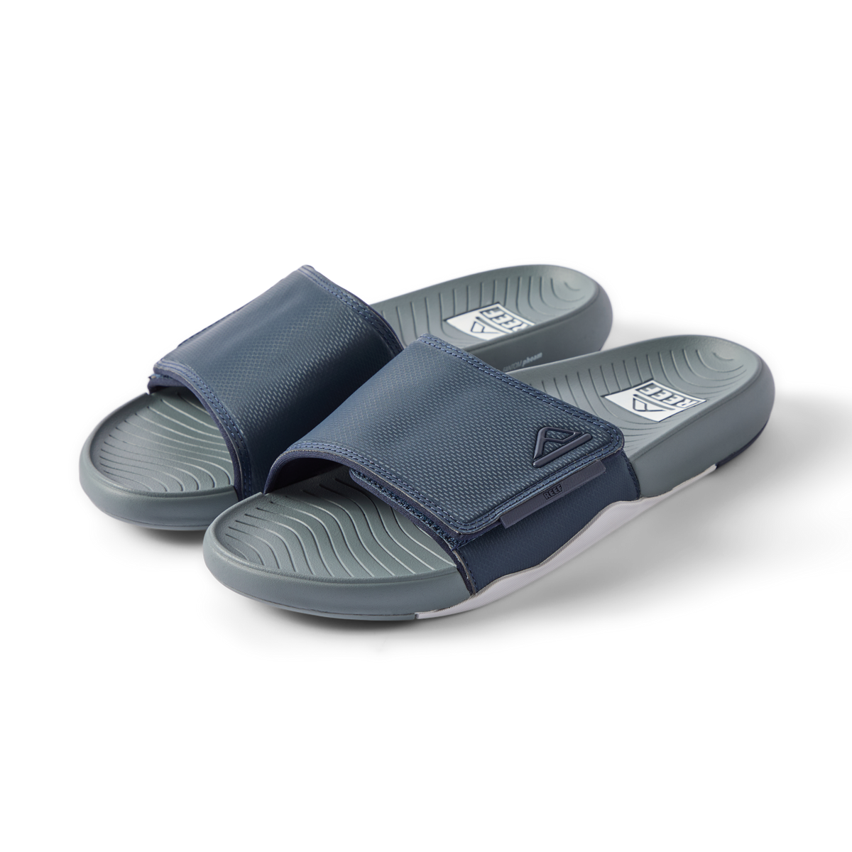 Pair of navy Phantom Slab slides facing right, showing cushioned footbeds with anatomical arch support.