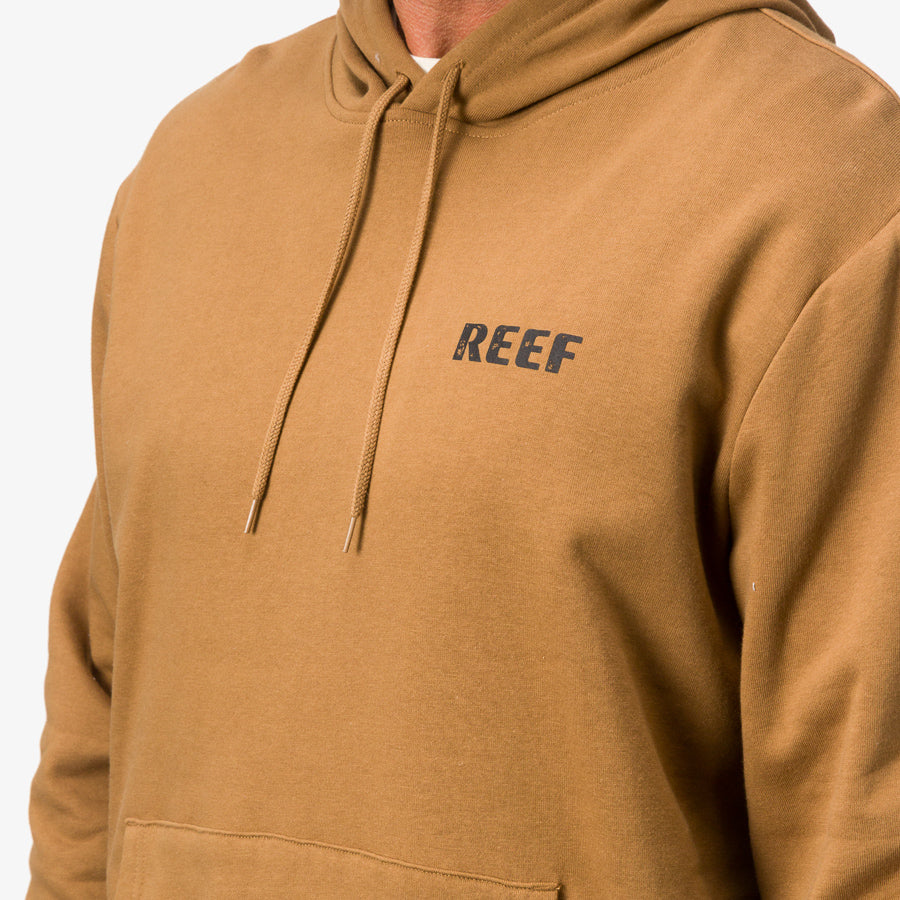 Close-up of chest and shoulders on men’s tan Wellie Too Hoodie with REEF logo and adjustable hood strings visible