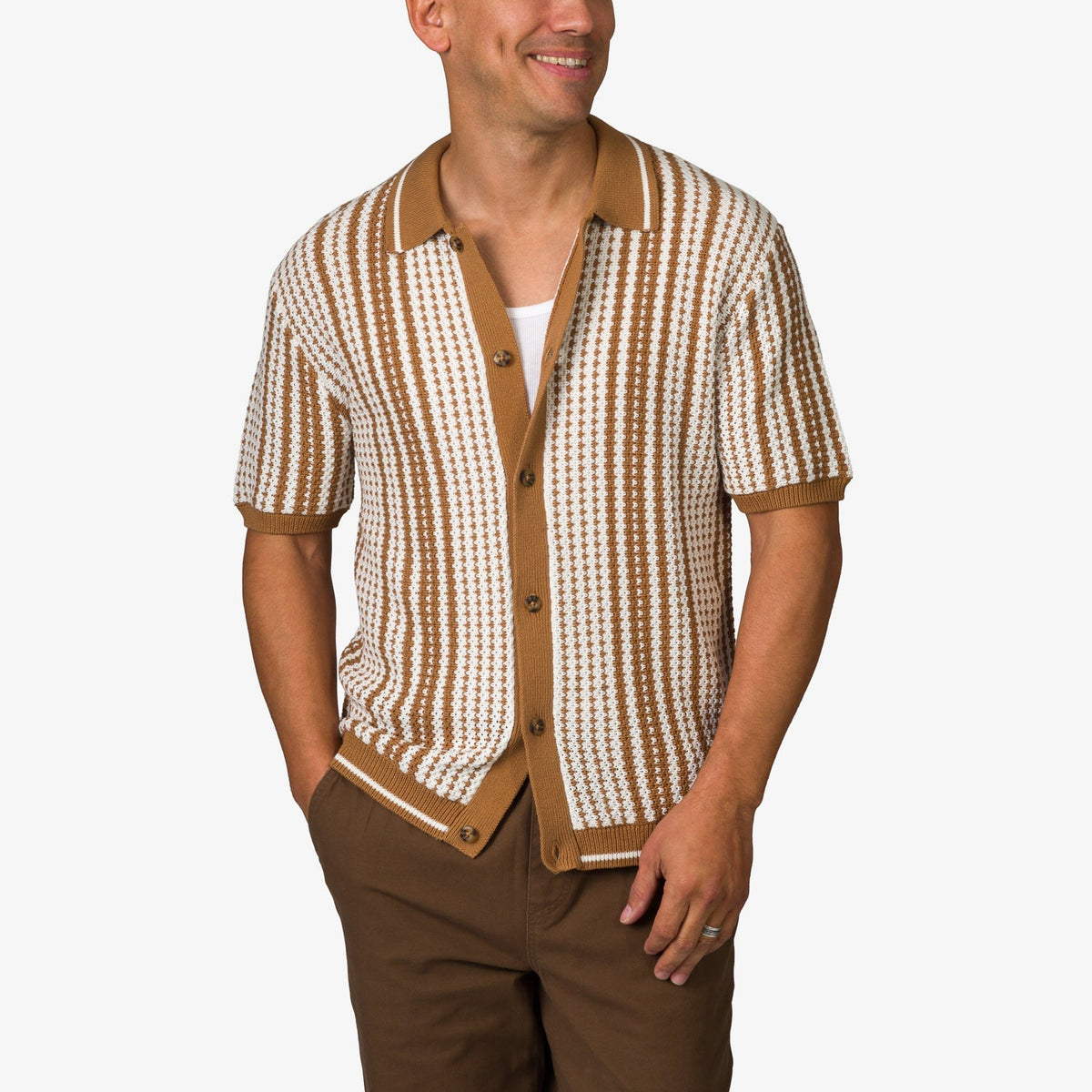 Adult male wearing a tan and white striped Cabana Knit Sweater with short sleeves and button front, smiling.