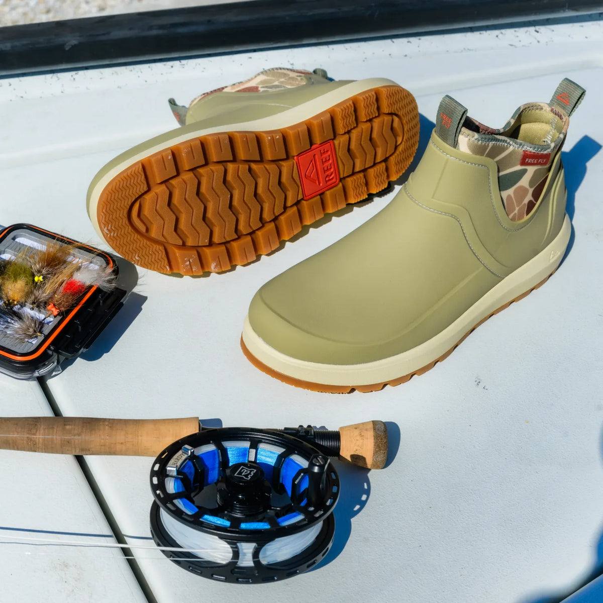 Free Fly X Scallywag men's green water-friendly boots facing right with patterned pull tab and durable tread outsole shown facing up