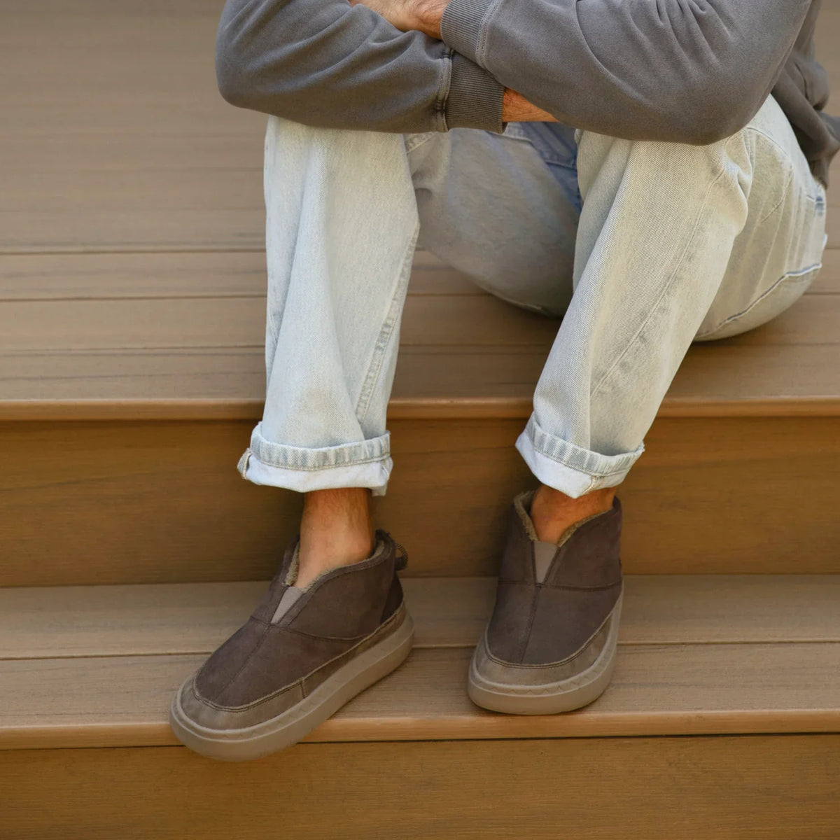 Feet wearing brown Rambler Hi shoes facing forward with soft-rebound cushioning and anatomical arch support, casual beach style