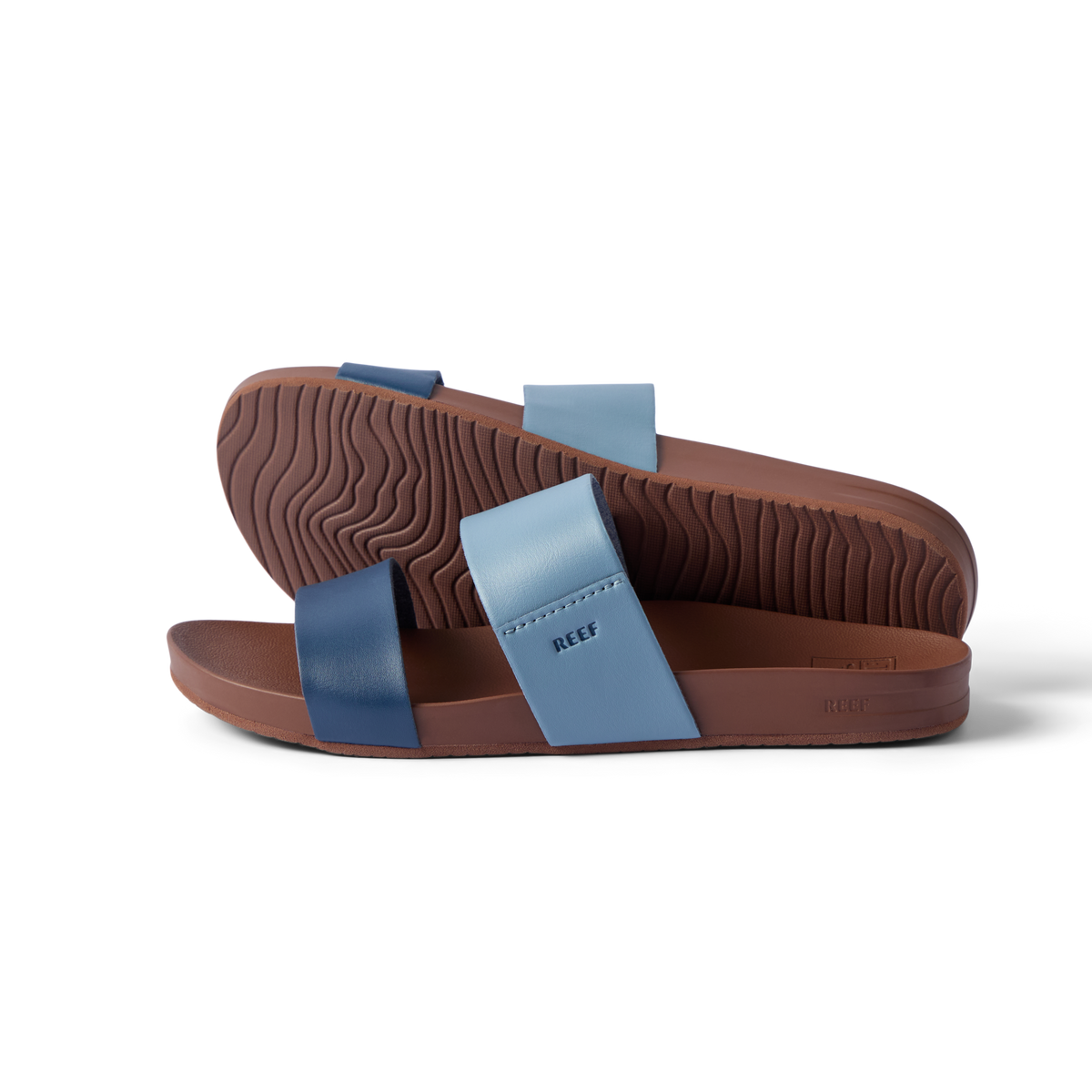 Pair of Cushion Vista sandals in blue tones, left sandal facing right and sole of right sandal visible, lightweight and cushioned.