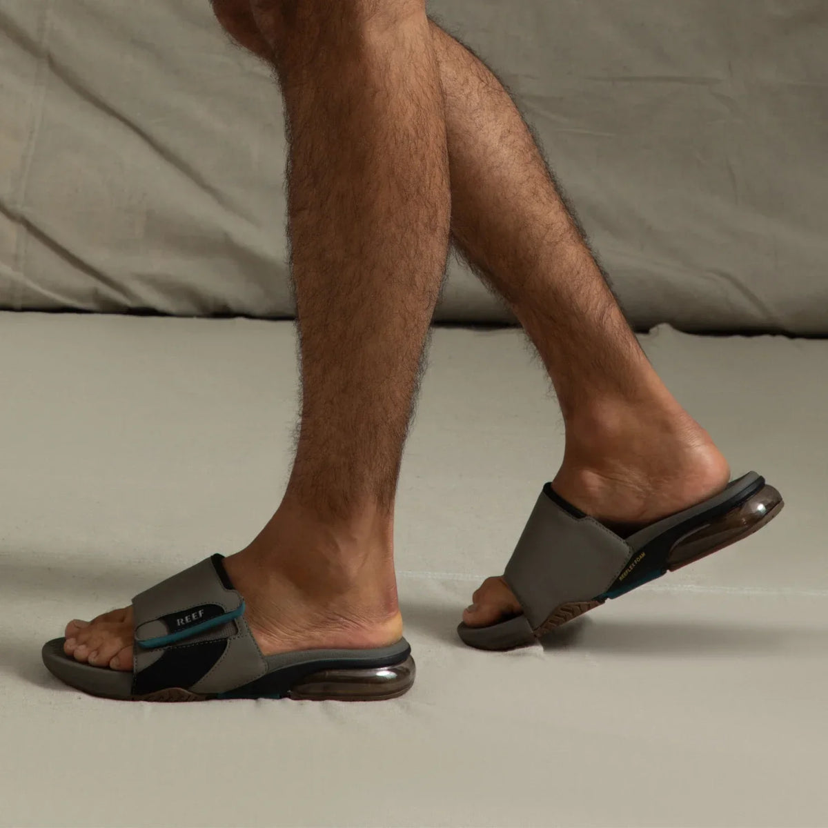 Pair of Fanning + Slide sandals facing left, brown and grey water-friendly men's slides with oversized airbag heel and arch support.