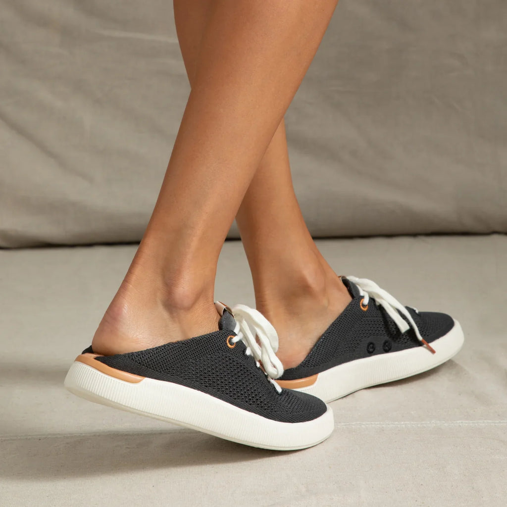 Reef Neptune footwear facing left, showing black breathable knit upper with cushioned sole and easy slip-on design.