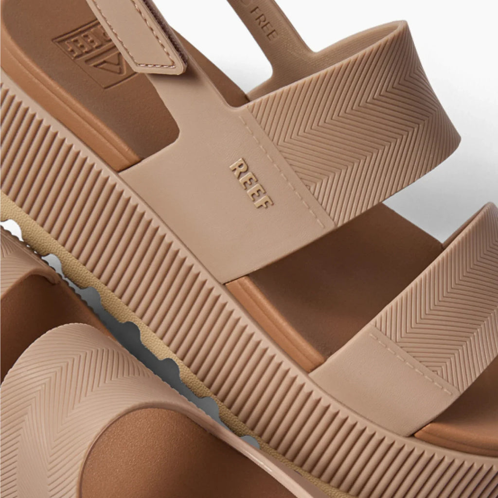 Close-up of the top and side of the Water Vista Higher sandal in warm taupe, showing straps and textured sole facing right