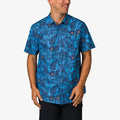 Man wearing a blue Tyson Classic Shirt with tropical print, front view, styled for beach and active lifestyles.