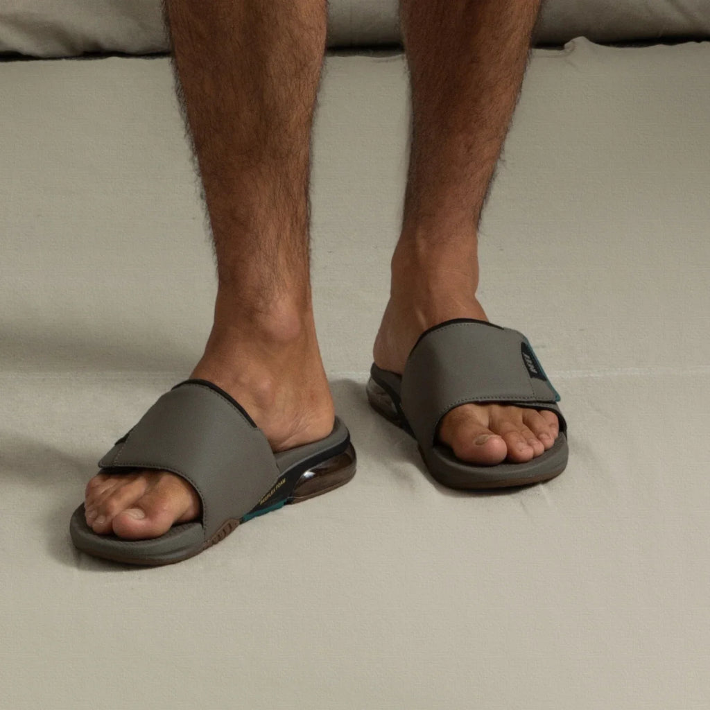 Fanning + Slide facing forward, men's grey water-friendly sandals with oversized airbag heel and cushioned molded footbed.