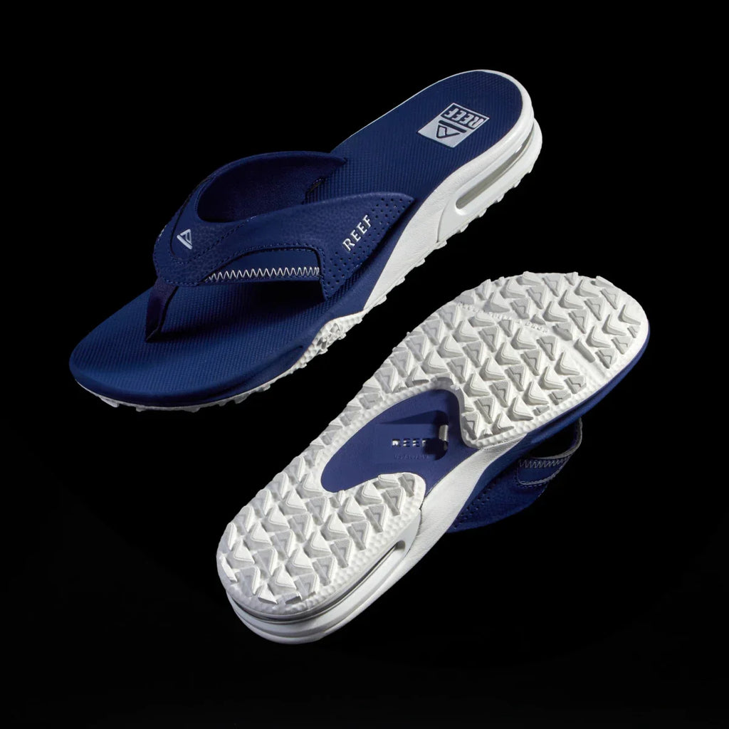 Pair of Fanning Pregame navy and white sandals, left showing top with arch support, right showing textured sole.