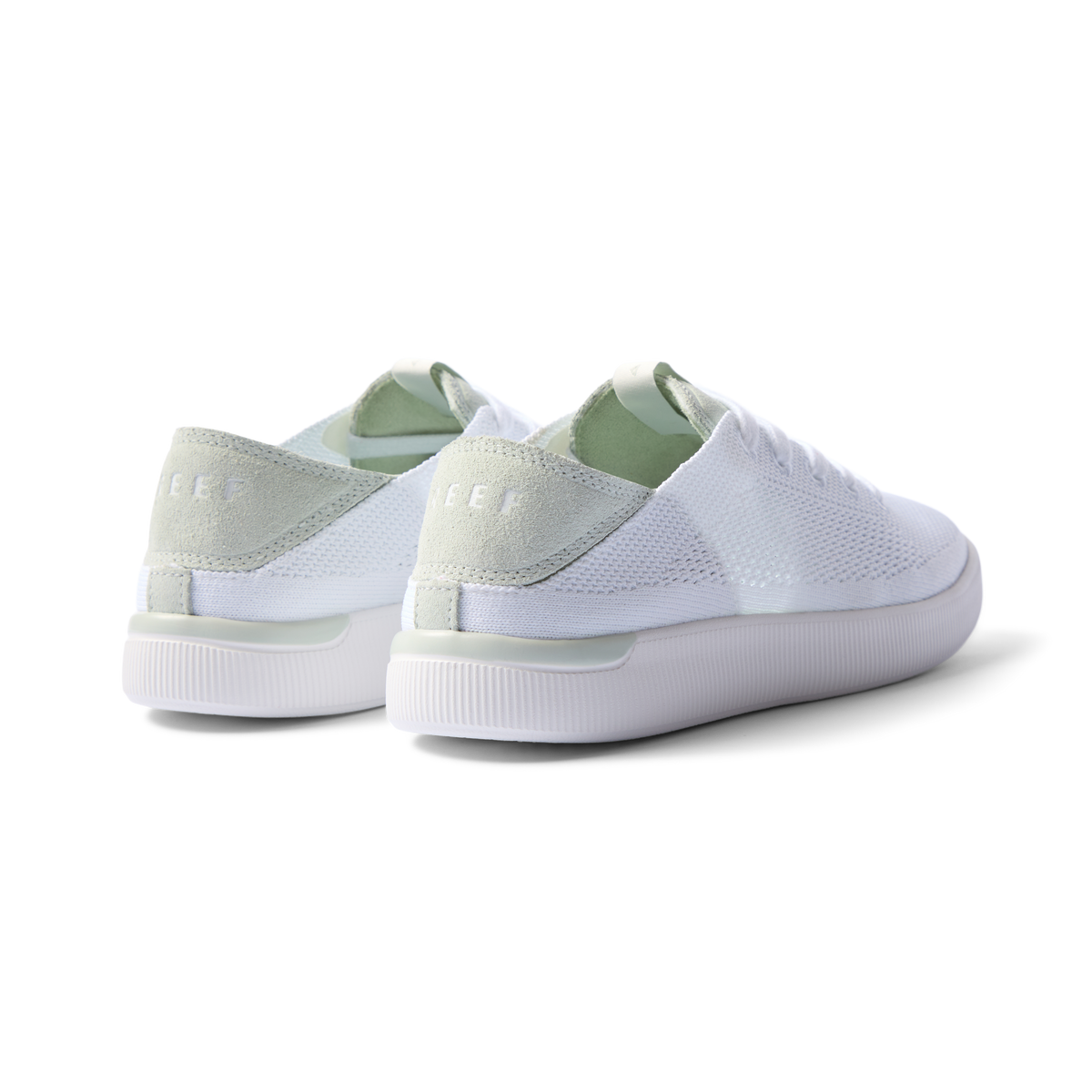 Reef Neptune women's sneakers showing rear and lateral sides facing left in white and dusty sage with cushioned arch support.