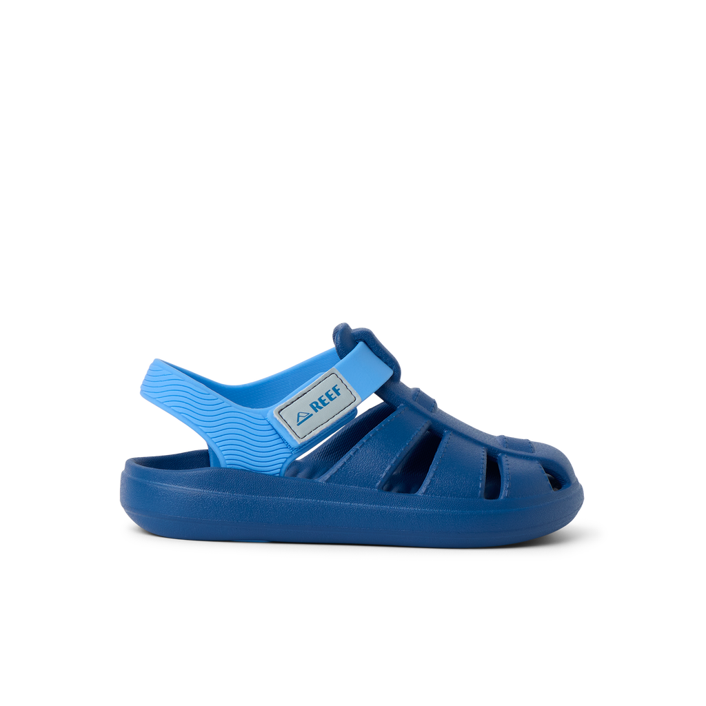 Little Totally Beachin boys sandal facing right, blue with adjustable strap, soft cushioning, and arch support.