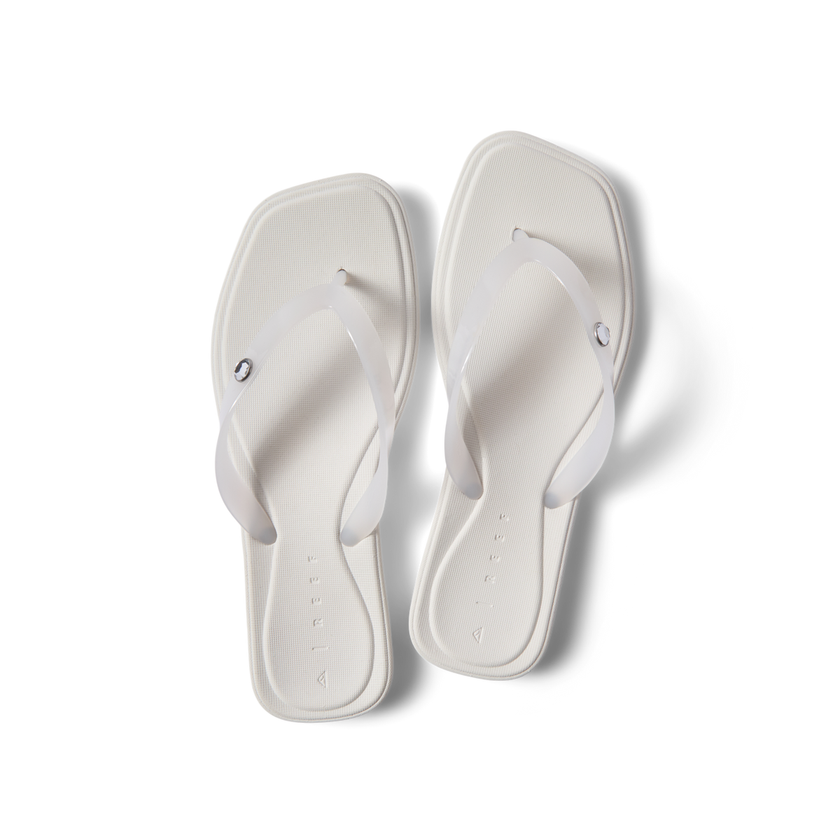 Solaye women's white sandals facing up, close-up of footbed and straps, beach-inspired comfort with arch support.