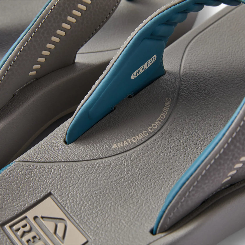 Close-up of the grey Cruiser sandal footbed facing up, showing arch support and blue shock pad strap with anatomic contouring.