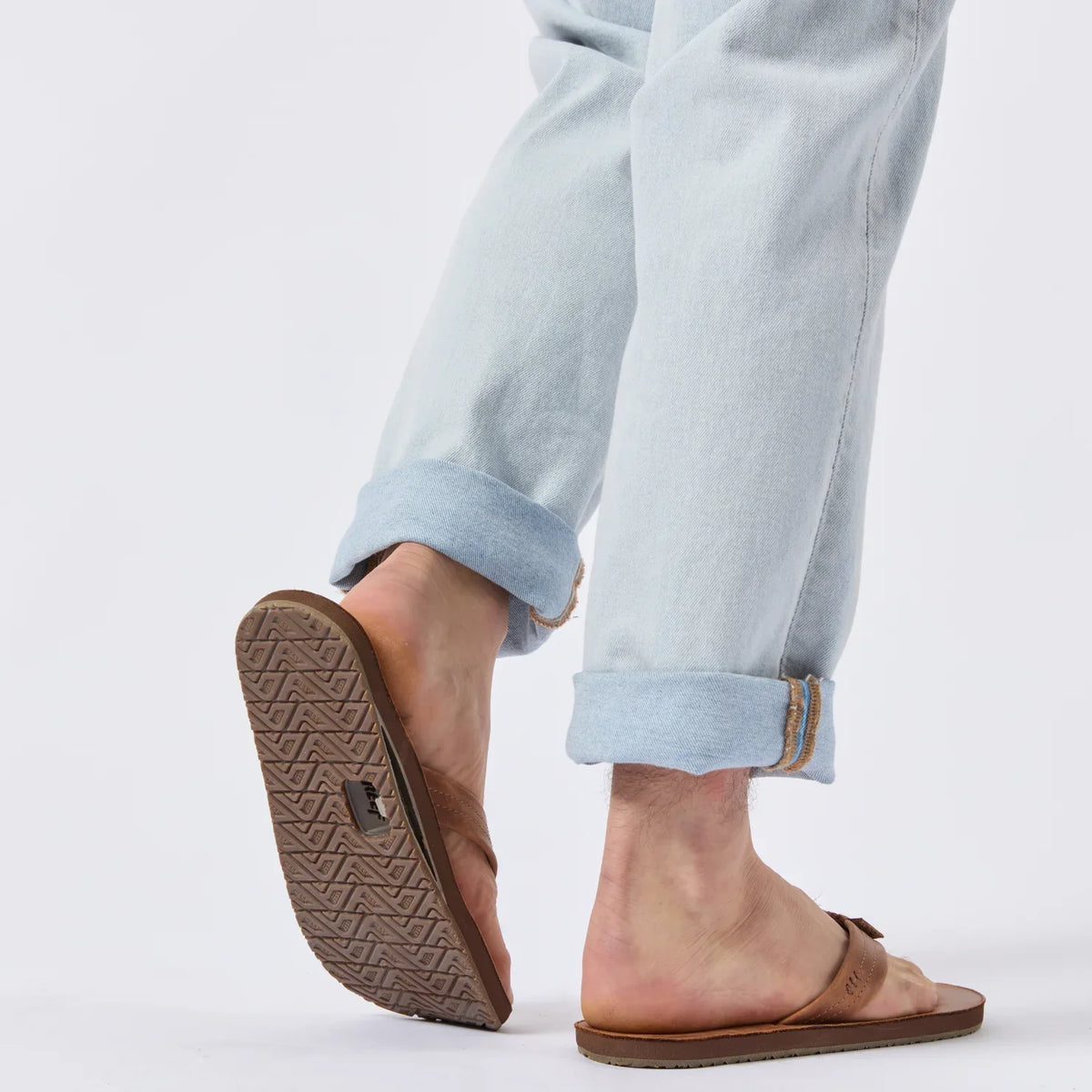 Reef Draftsmen sandals on a man’s feet, showing the sole facing backward with arch support and cushioned footbed.