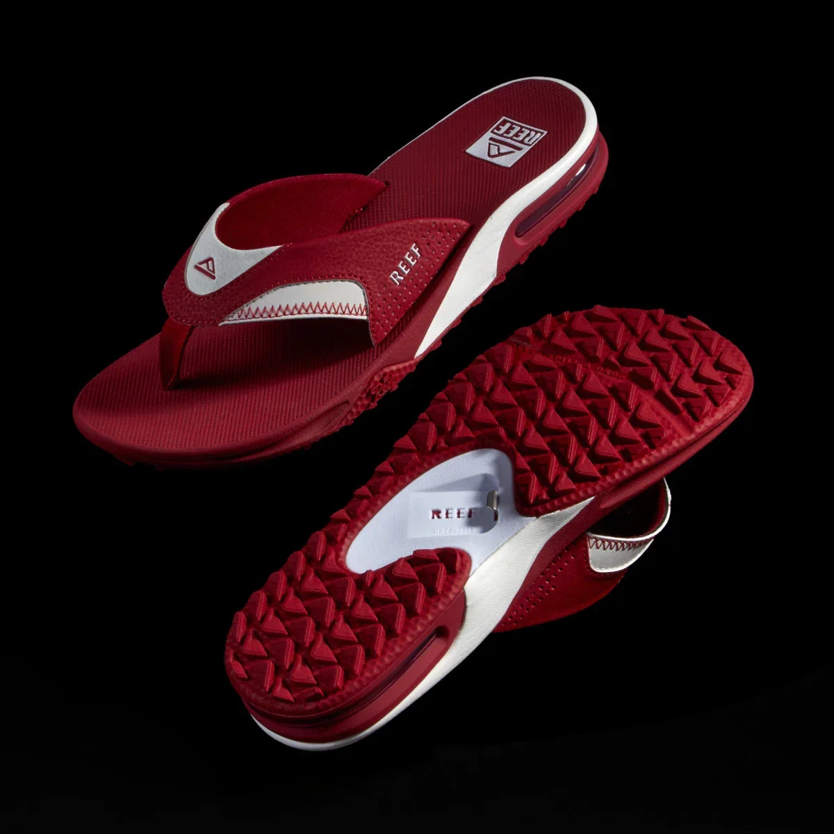 Fanning Pregame men's red and white flip flops, top view of right shoe facing left and sole view of left shoe facing right, comfort-focused design.