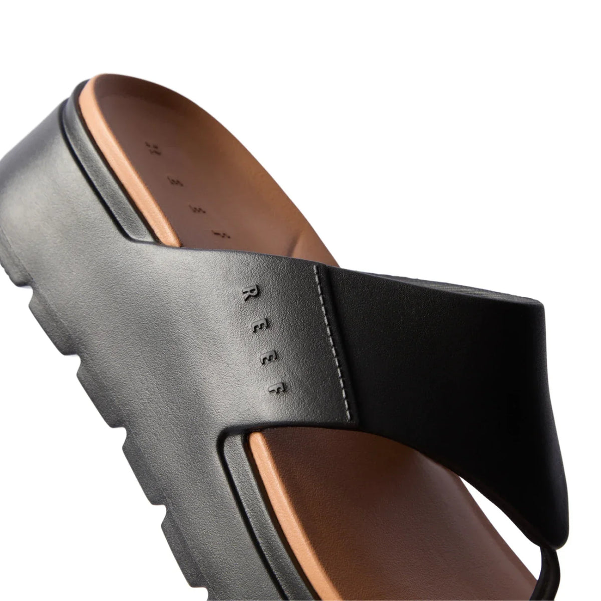 Cali Laguna black platform sandal close-up on right side strap and cushioned molded footbed with anatomical arch support