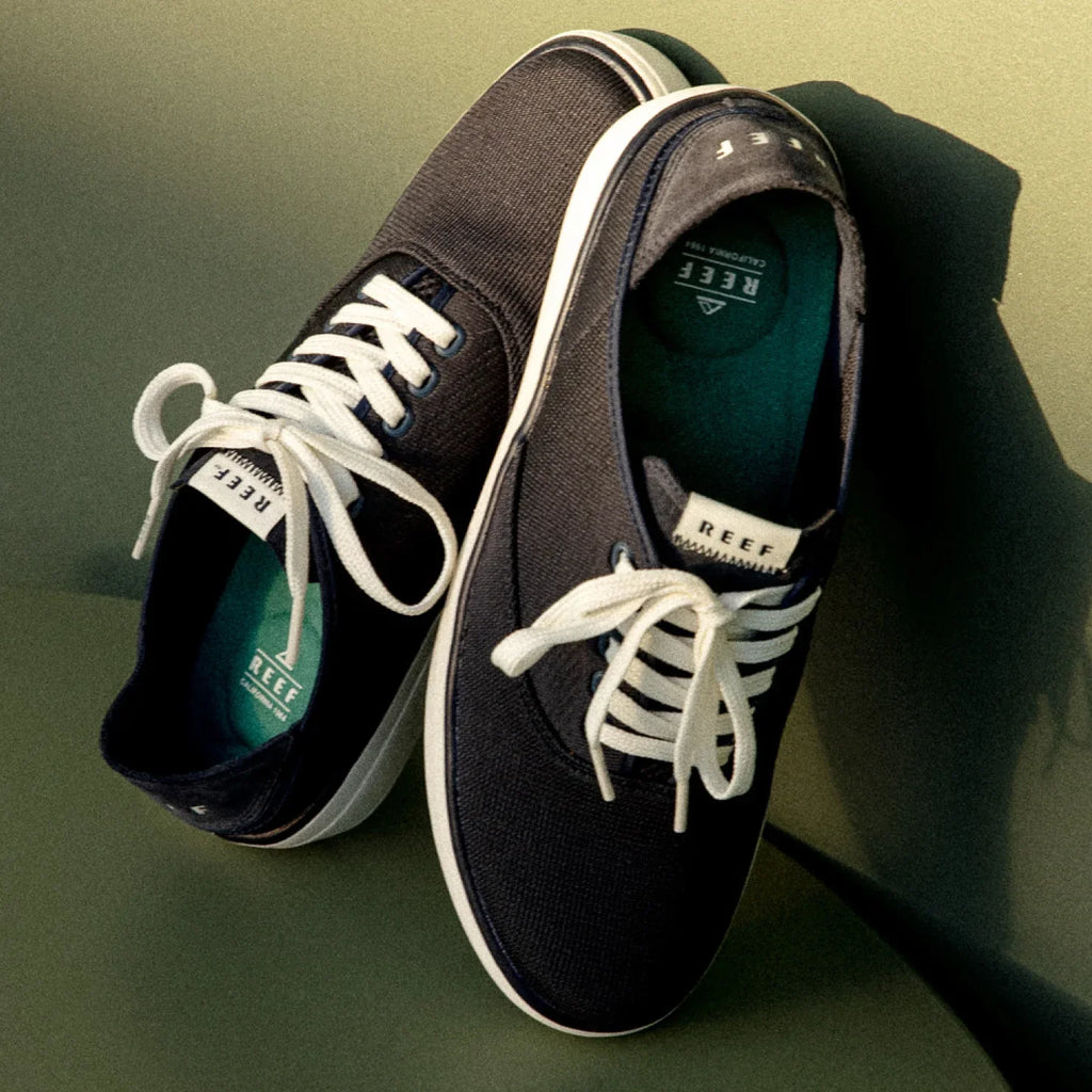 Pair of Neptune Lido navy canvas shoes for men, top-down view showing front and side with white laces and cushioned footbed.