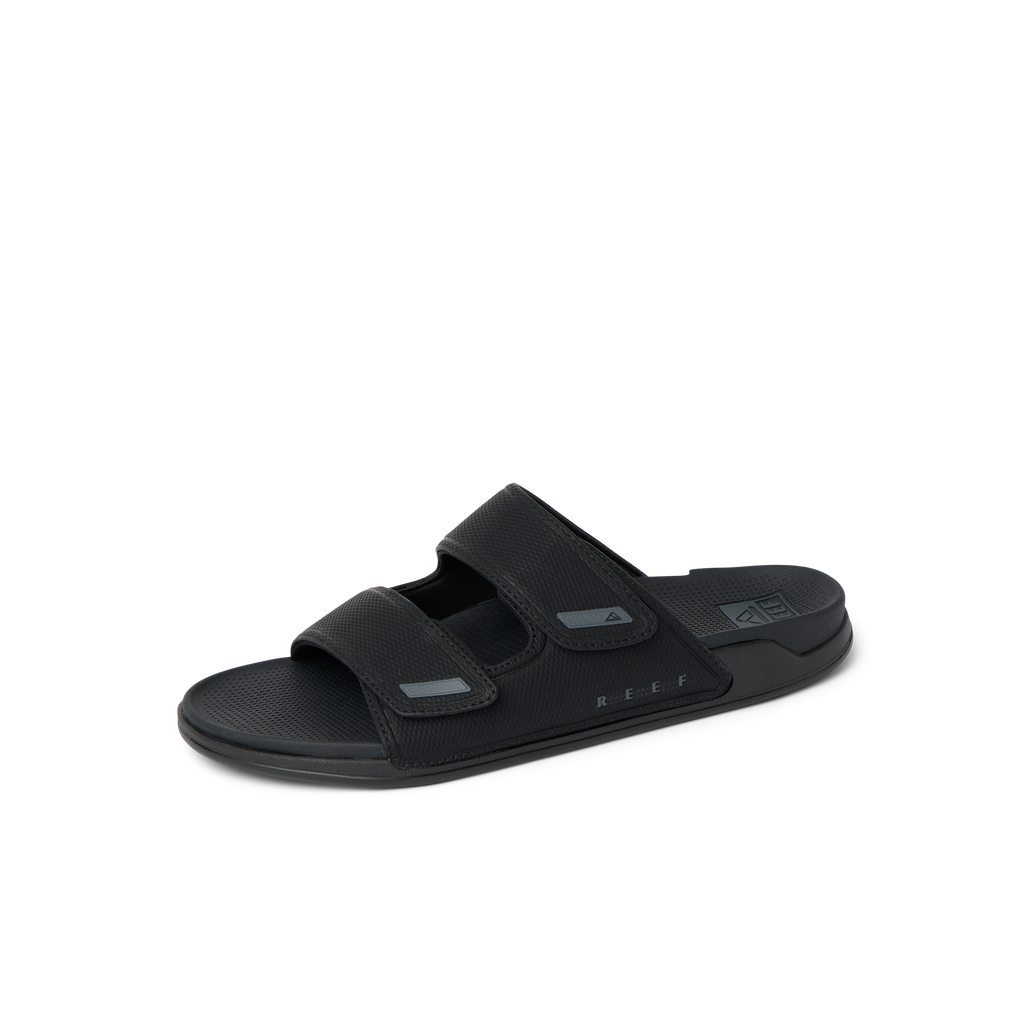 Phantom Tradewind men's black slide sandal facing right, showing top straps and cushioned footbed for all-day comfort.