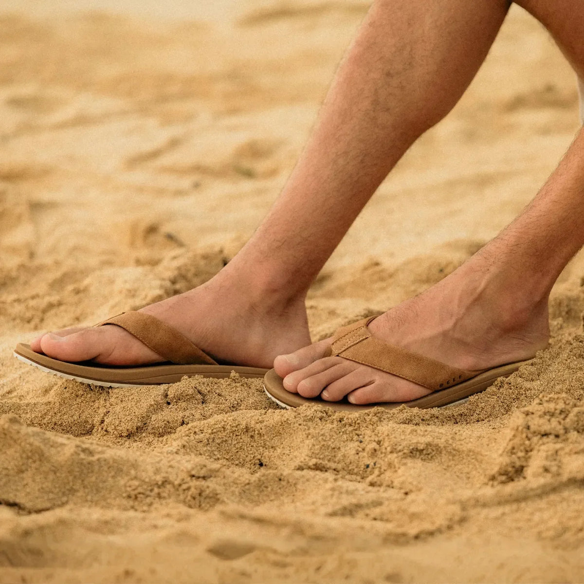Nox men's sandals facing right worn on sandy beach, featuring soft-rebound cushioning and anatomical arch support.