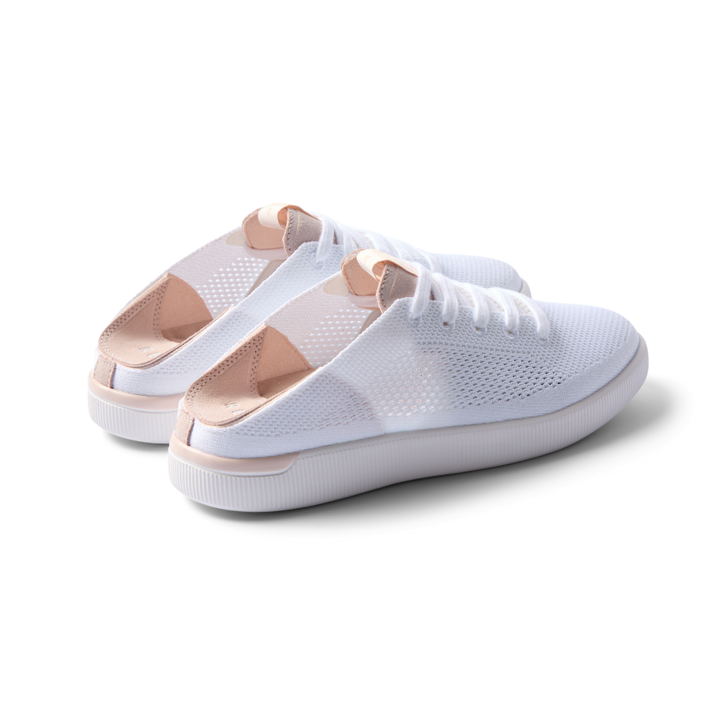 Reef Neptune women's white blush sneakers facing right, showing heel and side with breathable knit upper and cushioned sole.