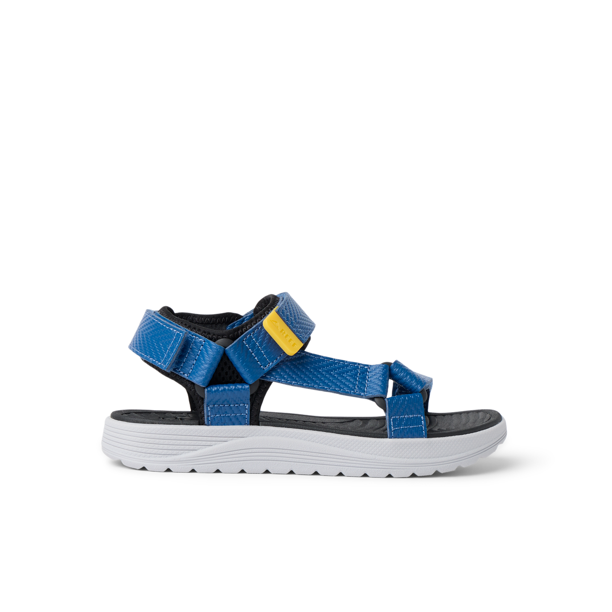 Kids Shoremazing sandal for boys facing right, showing side view with blue straps and white sole, designed for beach comfort.