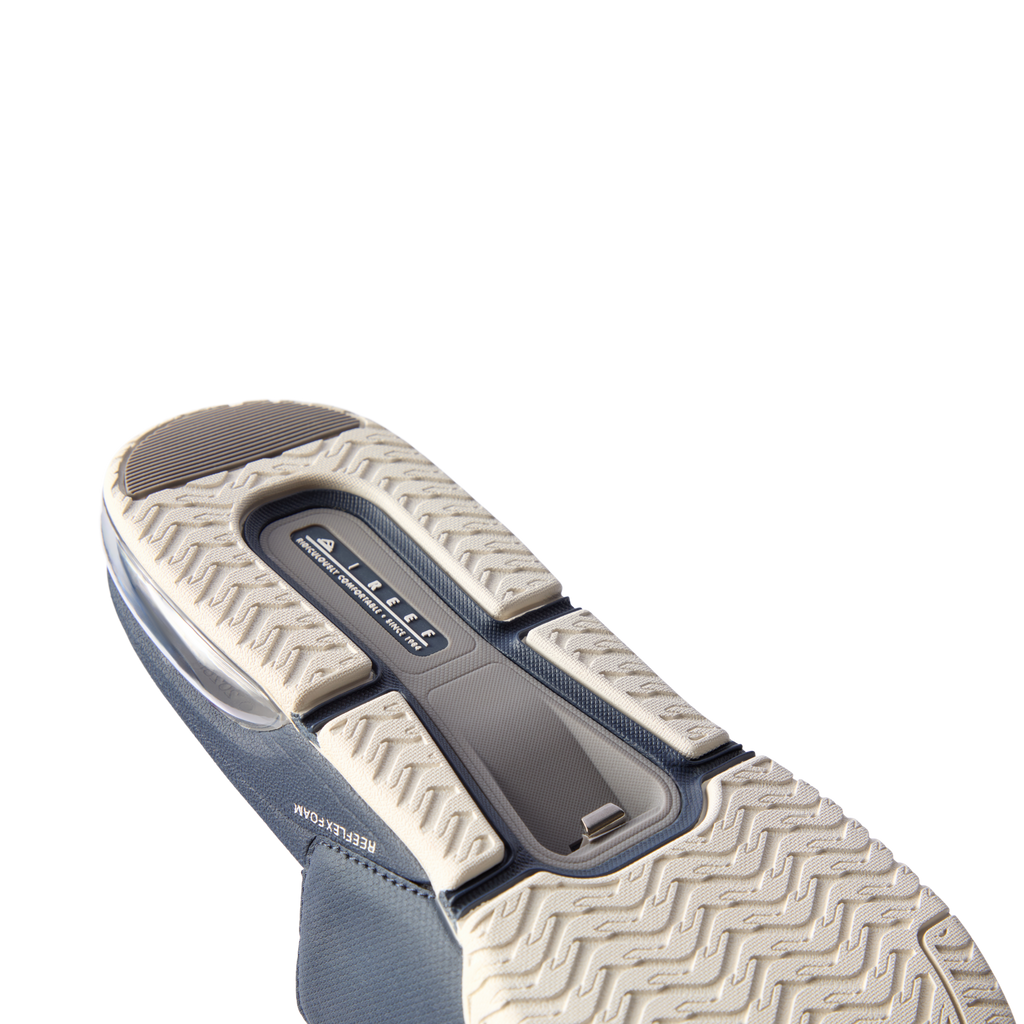 Fanning + Slide sole facing up showing navy blue water-friendly slide with cushioned REEFlex EVA platform and arch support