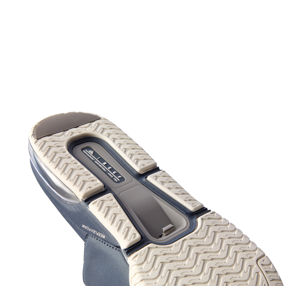 Fanning + Slide sole facing up showing navy blue water-friendly slide with cushioned REEFlex EVA platform and arch support