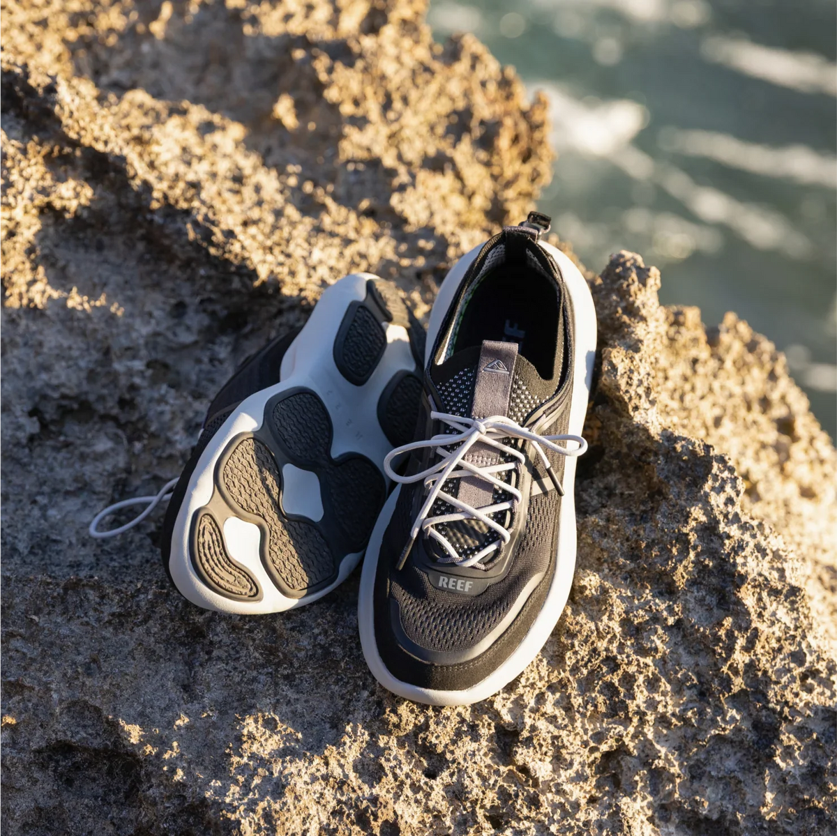 Shorebreak TRV men's black sneaker facing forward and sole up, surf-inspired with anatomical arch support and cushioning.
