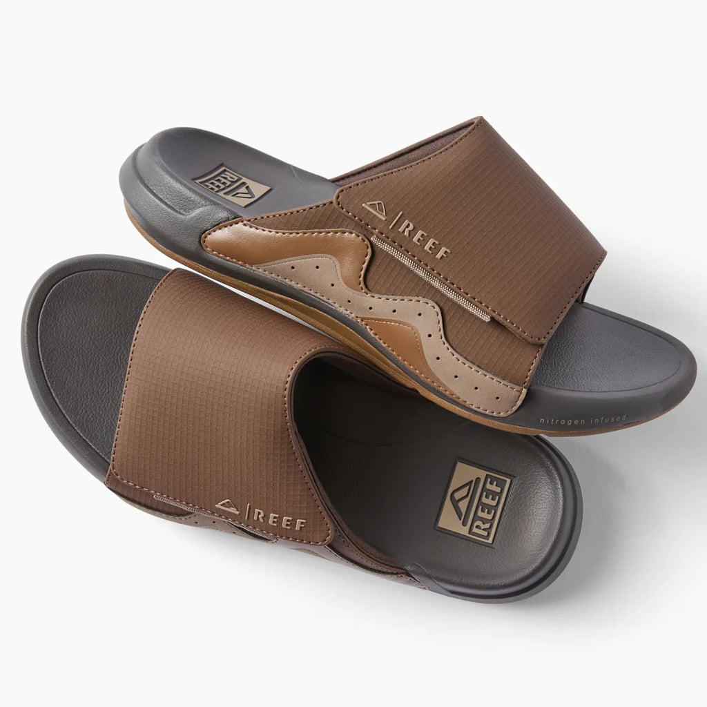 Top view of brown Cruiser Slide men's sandals with anatomical arch support and cushioned footbed facing right and left.