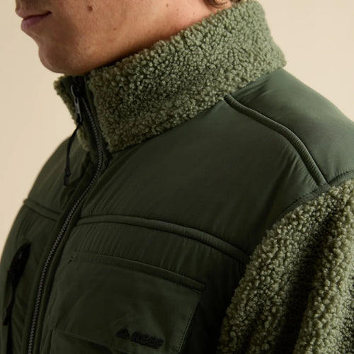 Close-up of the upper left side of the Cooke Sherpa Jacket showing olive green sherpa collar and fabric with chest pocket detail