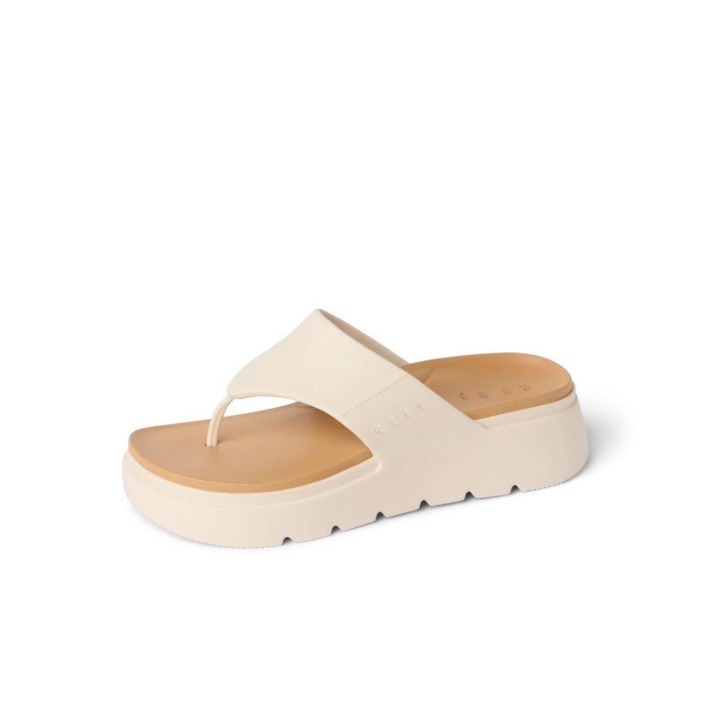 Cali Laguna sandal facing right, close-up of platform toe post with extra cushioning and arch support in white.