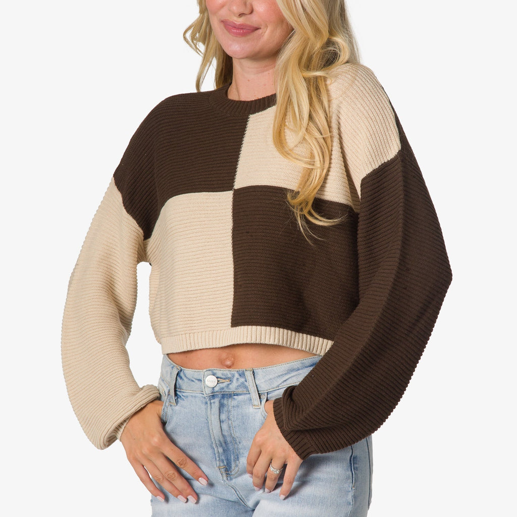 Woman wearing a colorblock Carrie Sweater in cream and brown, front-facing, showing cropped length and relaxed fit sleeves.