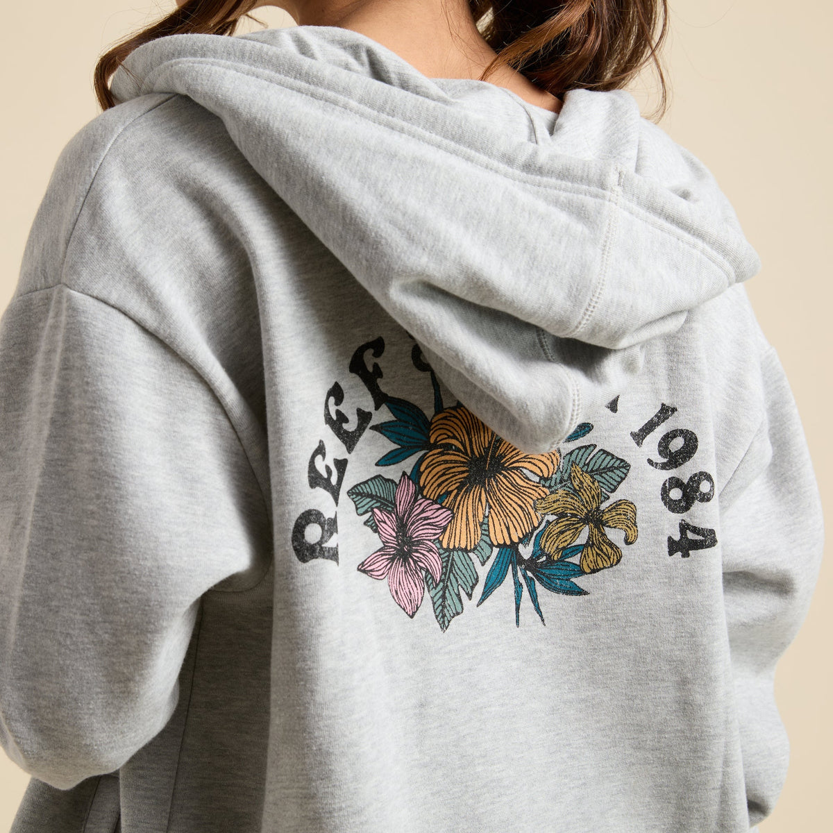 Brittany Fleece Full Zip hoodie back view showing floral REEF 1984 logo, soft fabric, and comfortable beach-inspired design.